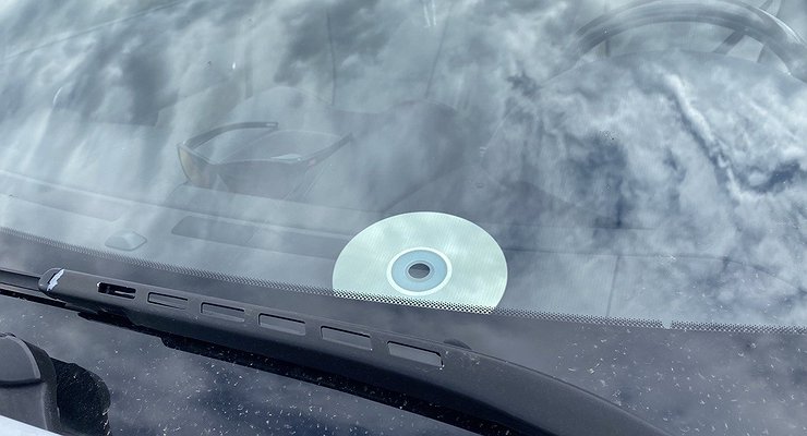 Why do drivers stick CDs upside down under the windshield?