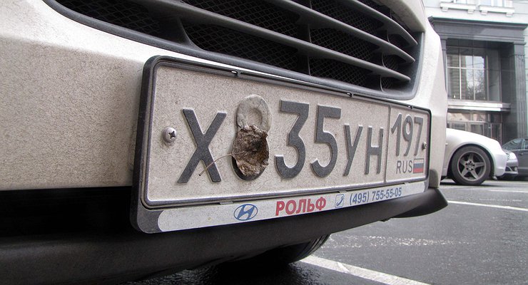 Why do some car owners spray their license plates with hairspray?
