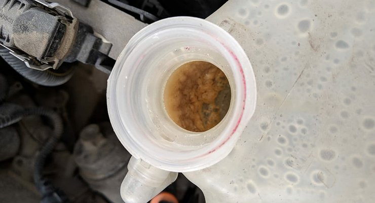 Why do air bubbles suddenly appear in the new antifreeze, and what threatens it?