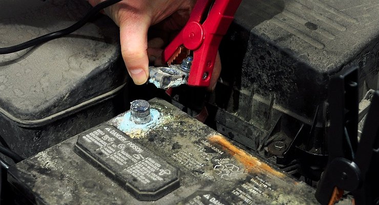 What should be done to prevent a sudden discharge of a car battery?