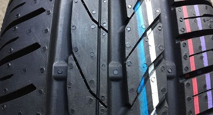 Why are new car tires covered with colorful stripes?
