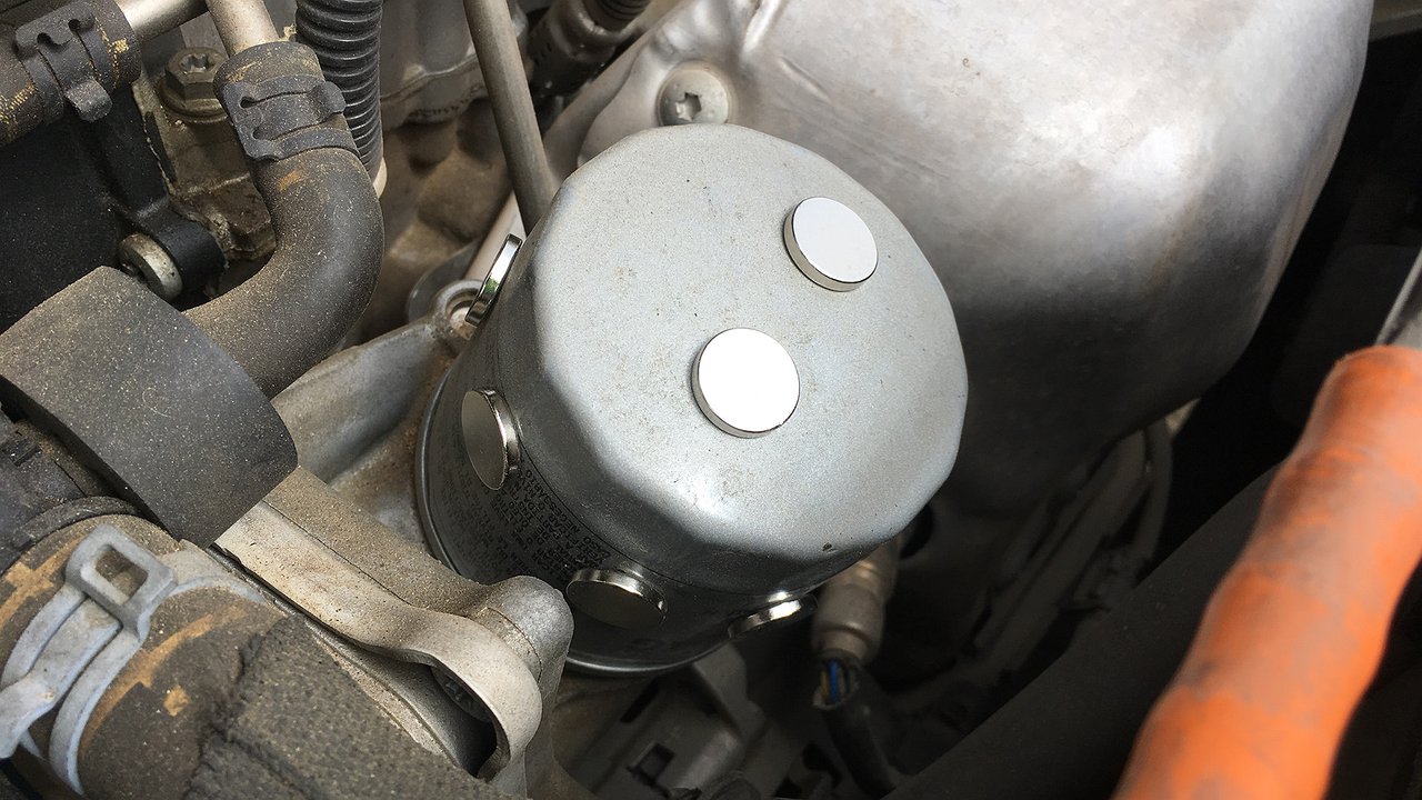 Why is it necessary to put a magnet on the oil filter of every new car?