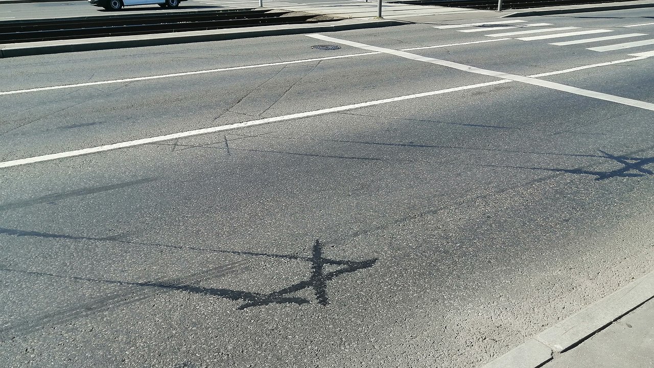 What do the black symbols on the sidewalk at intersections mean?