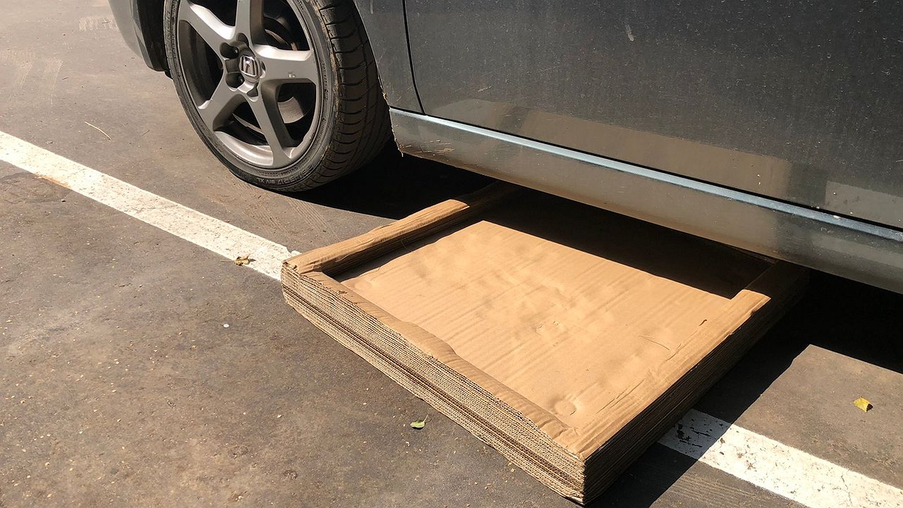 Why do experienced car owners collect cardboard from landfills?