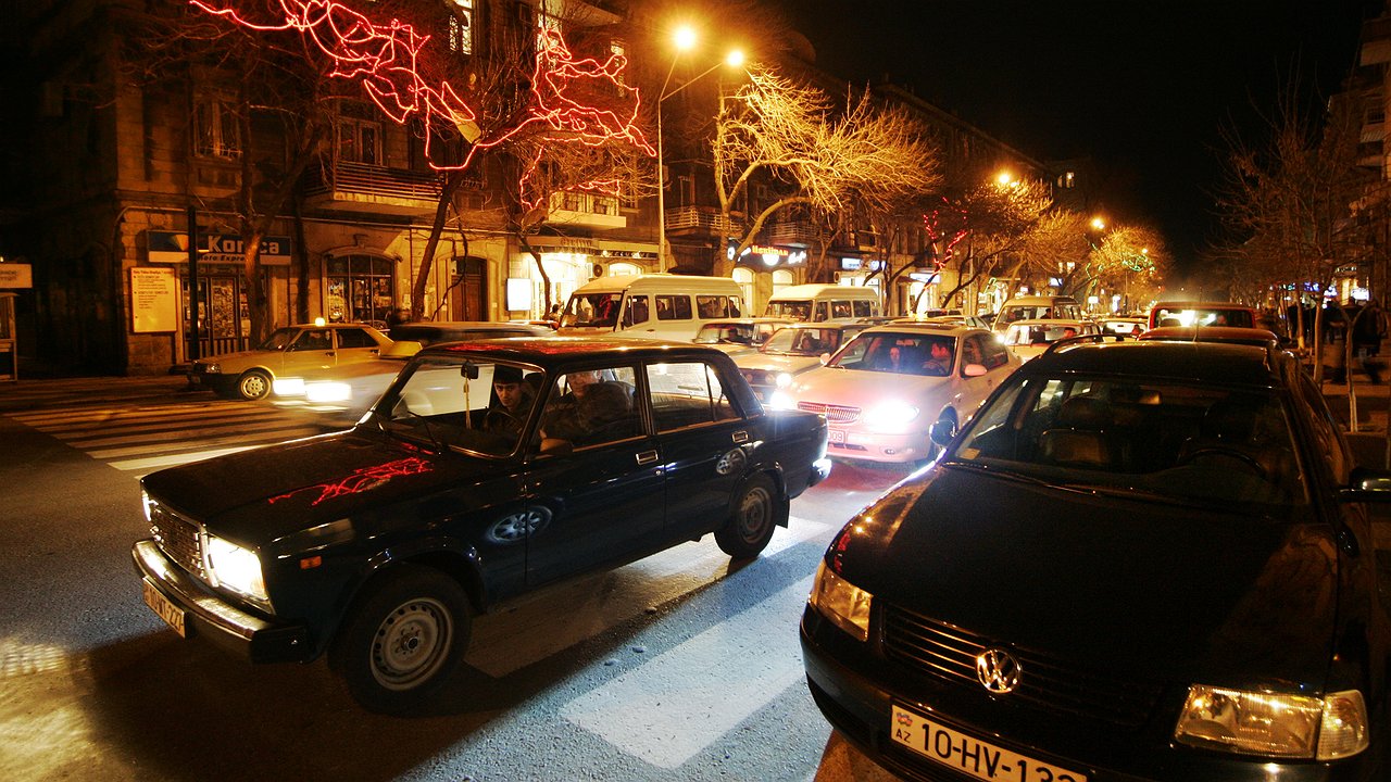 Why is it not recommended to turn on the interior lights when driving at night?